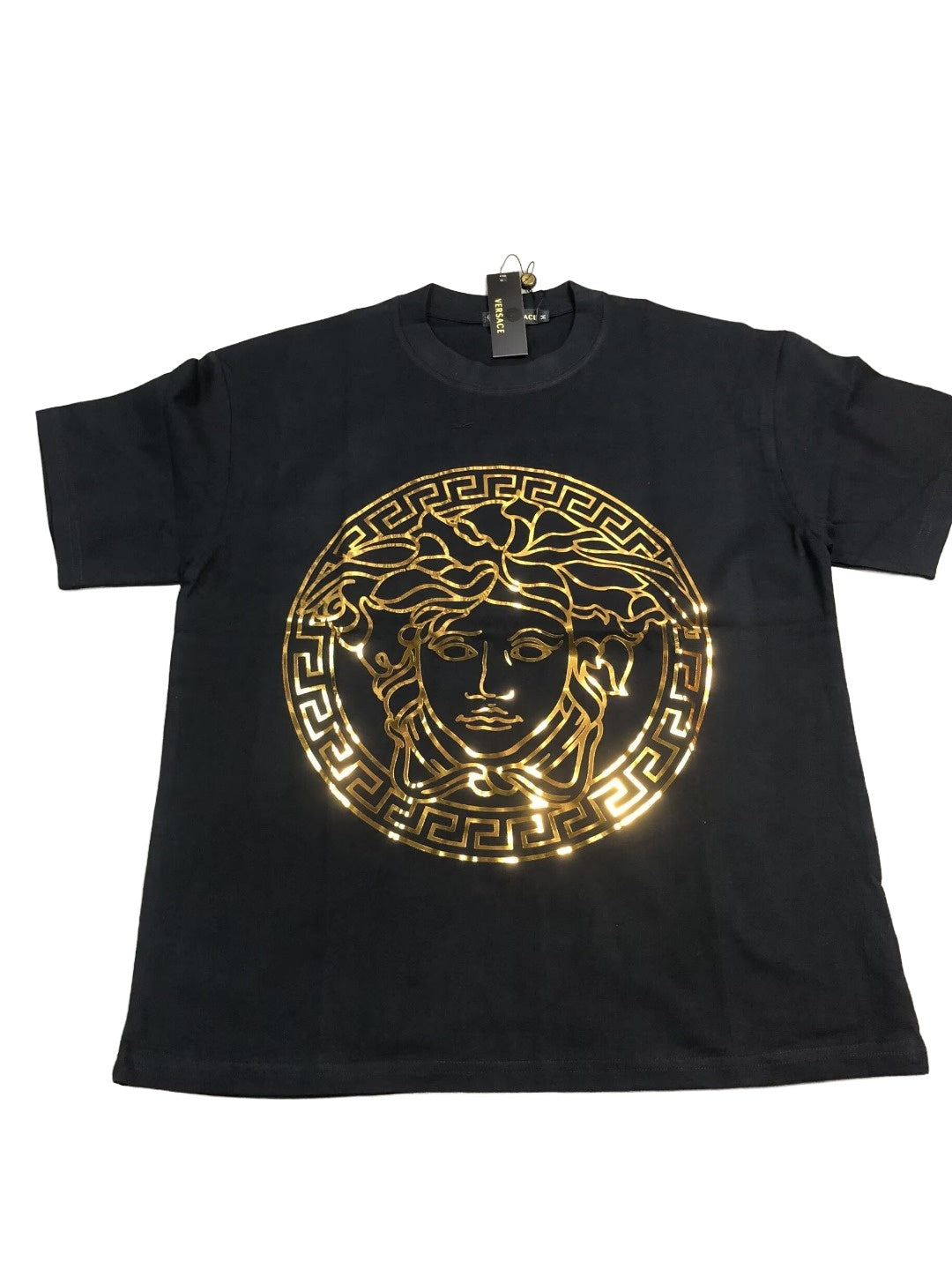 Oversized metallic gold Medusa T-shirt on white background